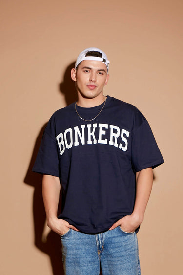 Navy blue oversized signature T-shirt by Bonkers Corner, featuring a relaxed fit and casual style on a mannequin.