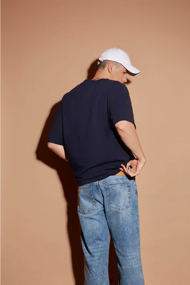 Navy blue oversized T-shirt by Bonkers Corner featuring a signature logo print on the front.