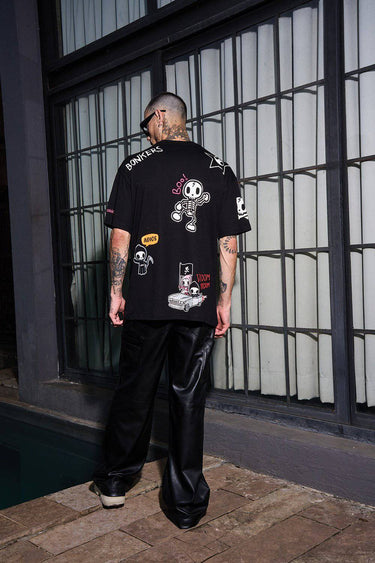 Bonkers Corner Tokidoki oversized T-shirt featuring colorful all-over cartoon character print on soft fabric.