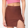 Mocha solid A-line slit skirt from BonkersCorner store, showing the skirt's flowy fabric and slit detail.
