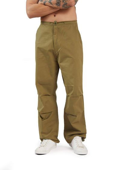 Man wearing olive parachute pants styled for a relaxed casual look. A versatile example of men’s Valentine’s Day outfit ideas, showcasing a smart casual Valentine’s Day outfit men can wear for comfortable yet stylish dinner date styling.